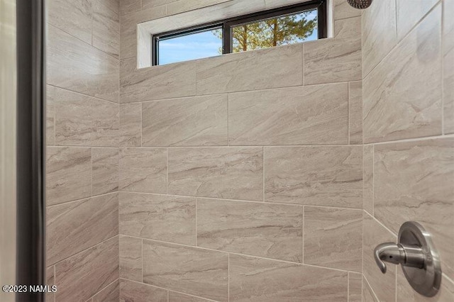 bathroom with a tile shower