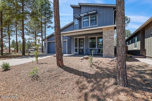 view of front of house featuring covered porch and a garage