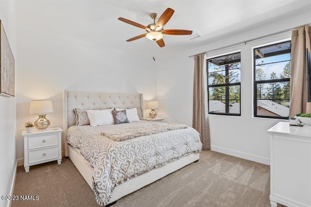 bedroom featuring light carpet and ceiling fan