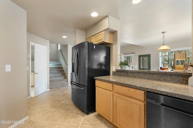 4435 E Savannah Cir, Flagstaff, AZ 86004 - kitchen with baseboards, light brown cabinets, light tile patterned floors, black fridge, and dishwasher