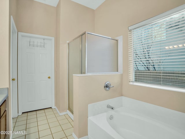 bathroom featuring tile patterned floors, separate shower and tub, and vanity