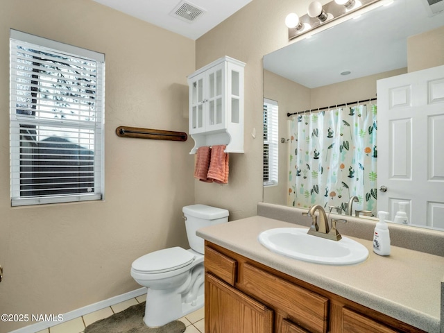 bathroom featuring a shower with shower curtain, vanity, toilet, and tile patterned flooring