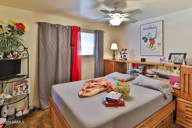 bedroom featuring ceiling fan and dark colored carpet