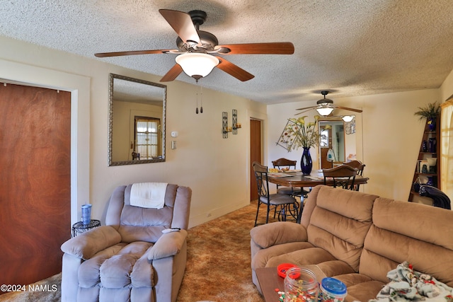 carpeted living room with ceiling fan and a textured ceiling