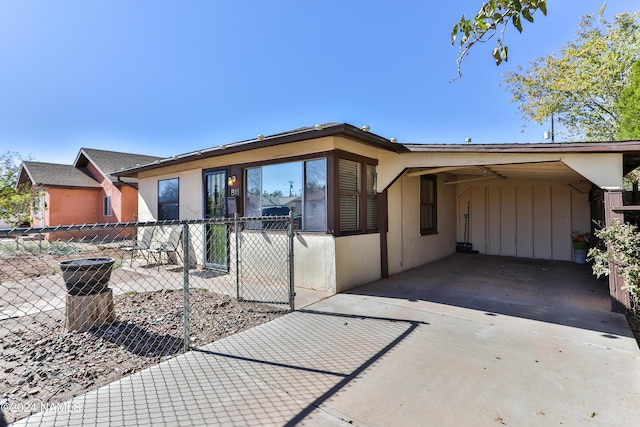 ranch-style home featuring a carport