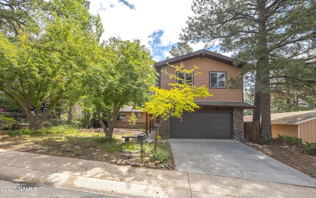 3494 N Andes Dr, Flagstaff, AZ 86004 - view of front of house featuring a garage, stone siding, and concrete driveway