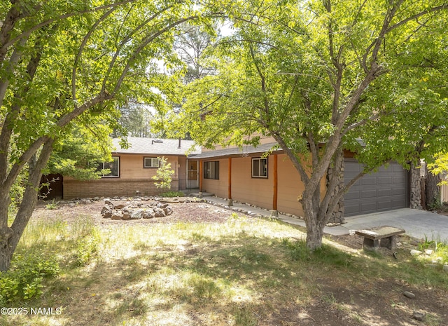 3494 N Andes Dr, Flagstaff, AZ 86004 - back of property with driveway and brick siding