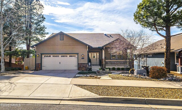 417 W Wulfenite Rd, Flagstaff, AZ 86005 - view of front of house with fence, driveway, and a garage