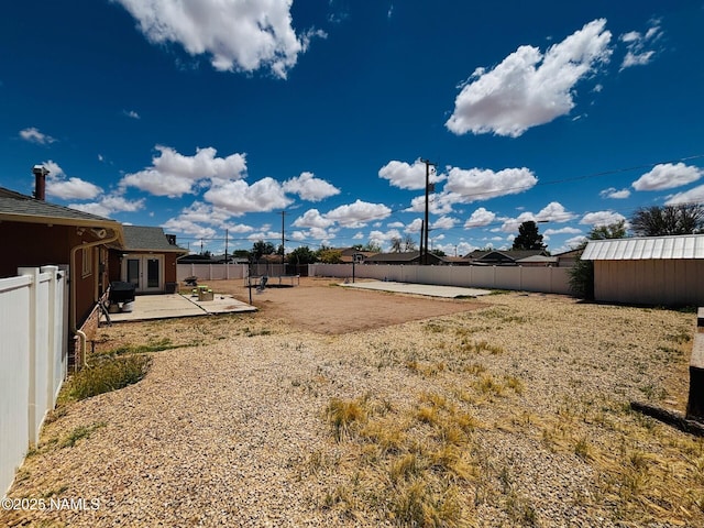 fenced backyard with a patio area