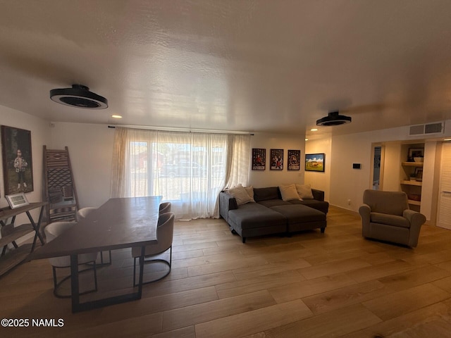 living room featuring wood finished floors and recessed lighting