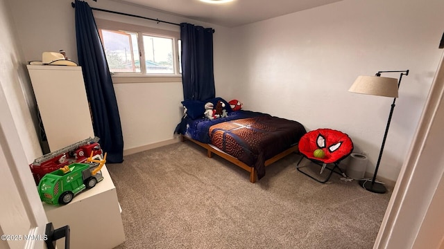 bedroom with carpet flooring and baseboards