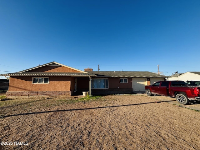 single story home with an attached garage and brick siding