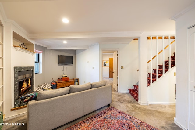 carpeted living room with a high end fireplace and ornamental molding