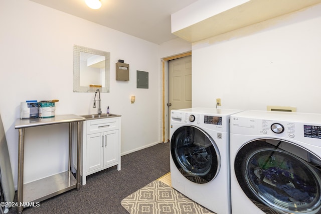 laundry room with washer and dryer, sink, electric panel, and cabinets