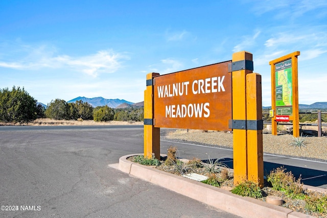 community sign with a mountain view