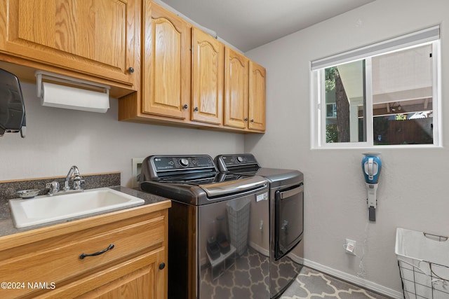 laundry room with sink, cabinets, and independent washer and dryer