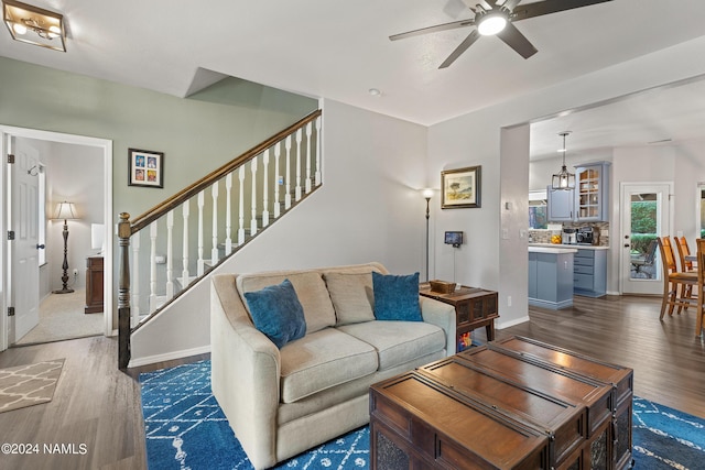 living room with ceiling fan and dark hardwood / wood-style floors