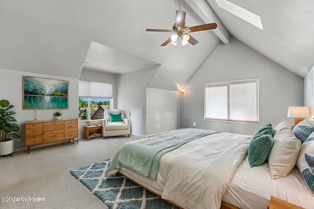 bedroom with carpet floors, vaulted ceiling with skylight, and ceiling fan