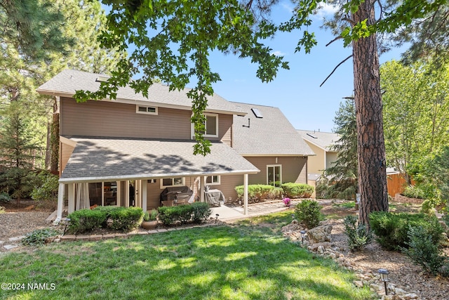 view of front of home with a front lawn and a patio