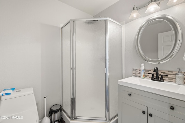 bathroom with vanity, toilet, decorative backsplash, and an enclosed shower