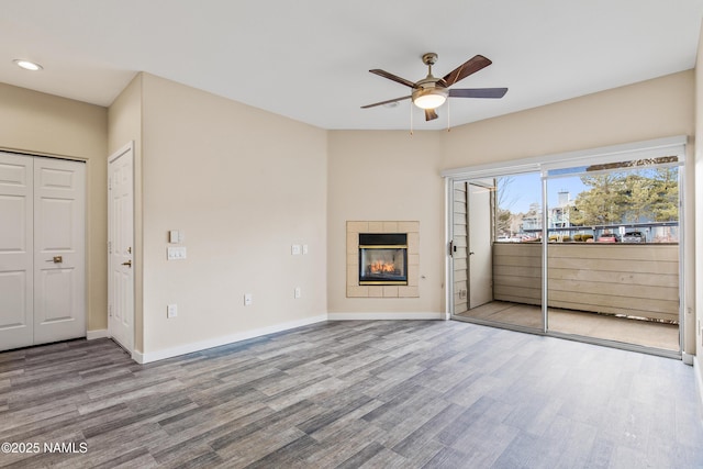 unfurnished living room with ceiling fan, a fireplace, and light hardwood / wood-style flooring