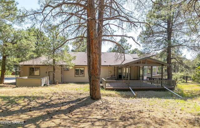 back of property with a wooden deck