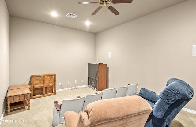 carpeted home office featuring ceiling fan