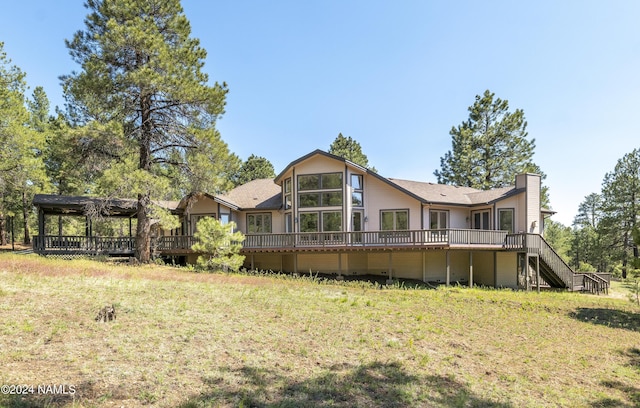 back of house featuring a gazebo, a lawn, and a wooden deck