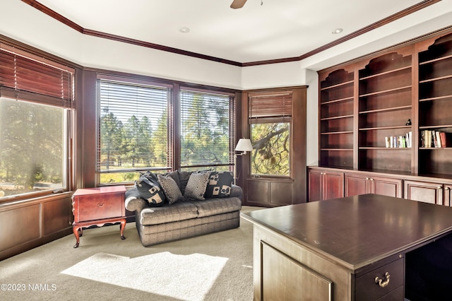 home office featuring light carpet, ceiling fan, and ornamental molding