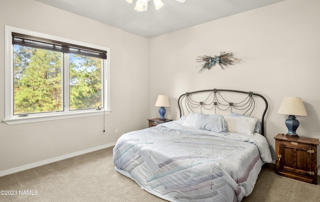 bedroom featuring ceiling fan and light carpet