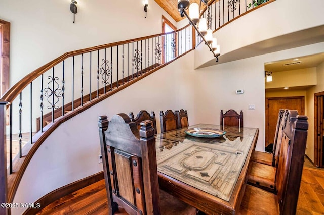 9178 N Snowbowl Ranch Rd, Flagstaff, AZ 86001 - dining room featuring wood finished floors, a high ceiling, and stairs