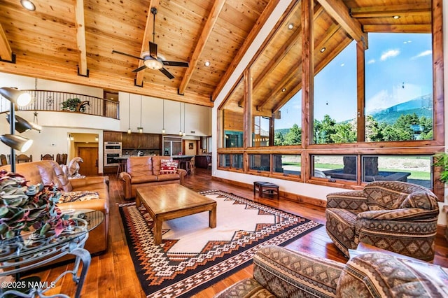 9178 N Snowbowl Ranch Rd, Flagstaff, AZ 86001 - living area with a wood ceiling with exposed beams, hardwood / wood-style flooring, a ceiling fan, and high vaulted ceiling