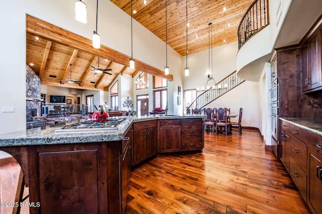 9178 N Snowbowl Ranch Rd, Flagstaff, AZ 86001 - kitchen with a wooden ceiling with exposed beams, high vaulted ceiling, dark wood finished floors, open floor plan, and pendant lighting