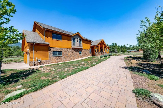 9178 N Snowbowl Ranch Rd, Flagstaff, AZ 86001 - view of front of property with stone siding, driveway, and board and batten siding