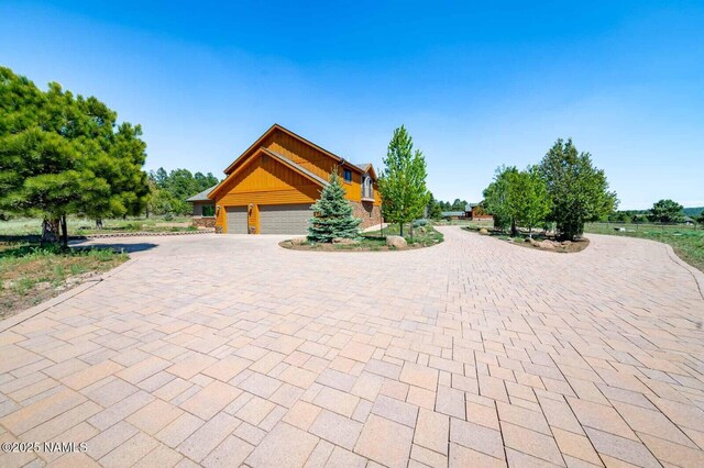 9178 N Snowbowl Ranch Rd, Flagstaff, AZ 86001 - view of front facade with decorative driveway and an attached garage