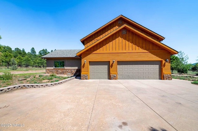 9178 N Snowbowl Ranch Rd, Flagstaff, AZ 86001 - view of front facade with stone siding, board and batten siding, and concrete driveway