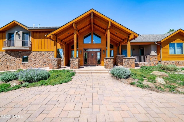 9178 N Snowbowl Ranch Rd, Flagstaff, AZ 86001 - view of front facade featuring stone siding, board and batten siding, and covered porch