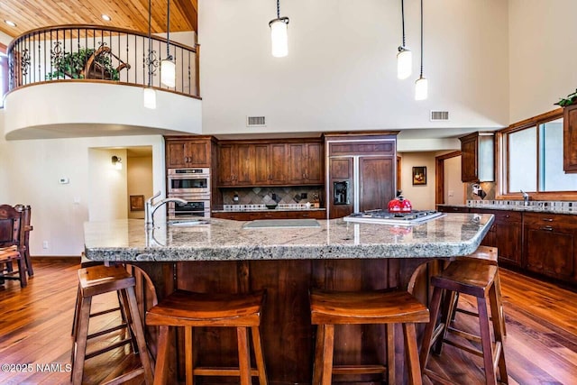 9178 N Snowbowl Ranch Rd, Flagstaff, AZ 86001 - kitchen featuring high vaulted ceiling, appliances with stainless steel finishes, dark wood-style floors, pendant lighting, and wooden ceiling