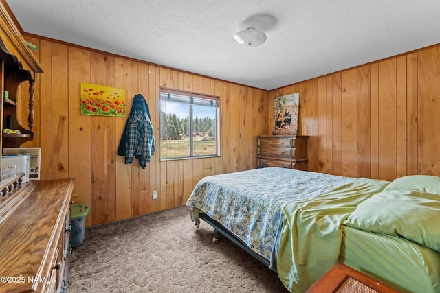 5735 White Tail Ln, Flagstaff, AZ 86005 - carpeted bedroom featuring wood walls and a textured ceiling