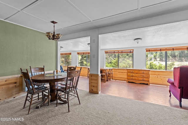 5735 White Tail Ln, Flagstaff, AZ 86005 - carpeted dining room featuring healthy amount of natural light, a chandelier, and a textured wall