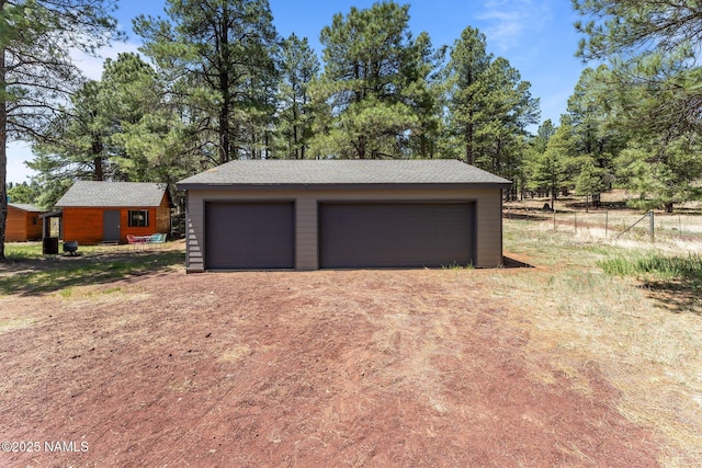 5735 White Tail Ln, Flagstaff, AZ 86005 - detached garage with view of wooded area