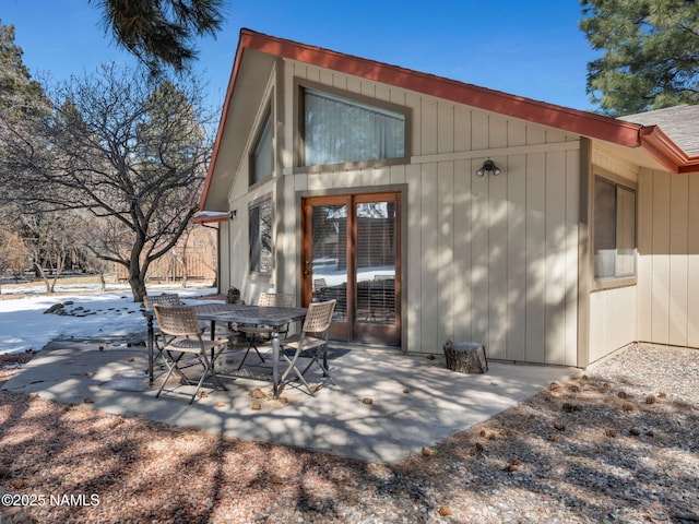 back of house featuring outdoor dining space and a patio area