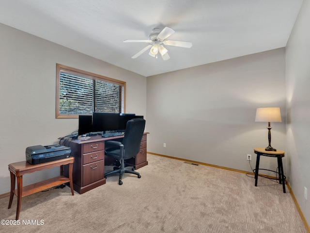 office area featuring baseboards, light carpet, visible vents, and a ceiling fan