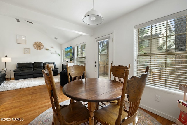 2548 S Gravel Ln, Flagstaff, AZ 86001 - dining room featuring wood finished floors, baseboards, lofted ceiling, and a healthy amount of sunlight