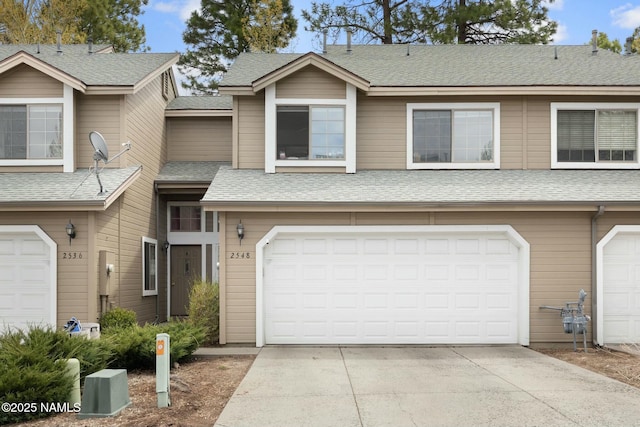 2548 S Gravel Ln, Flagstaff, AZ 86001 - townhome / multi-family property with a shingled roof, driveway, and an attached garage
