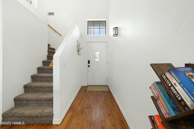 2548 S Gravel Ln, Flagstaff, AZ 86001 - entrance foyer with stairs, a high ceiling, hardwood / wood-style flooring, and baseboards
