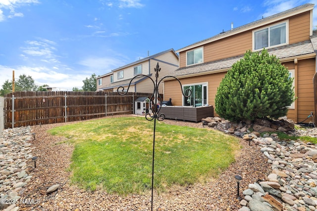 9119 W Arden Ln, Bellemont, AZ 86015 - back of property featuring a yard, a fenced backyard, outdoor lounge area, and a shingled roof