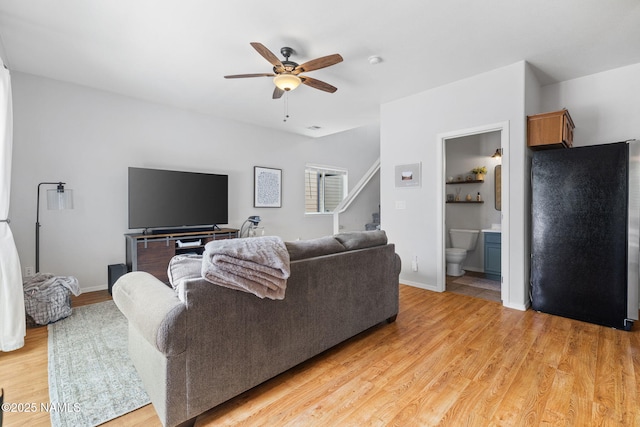 9119 W Arden Ln, Bellemont, AZ 86015 - living area with stairs, light wood finished floors, baseboards, and a ceiling fan
