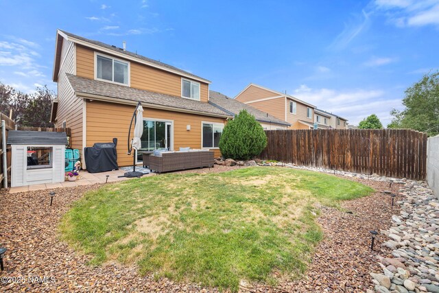 9119 W Arden Ln, Bellemont, AZ 86015 - back of property with an outdoor living space, a fenced backyard, a lawn, a patio, and roof with shingles
