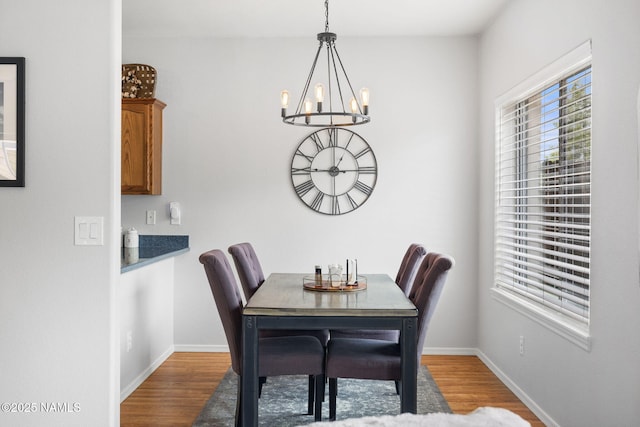 9119 W Arden Ln, Bellemont, AZ 86015 - dining area featuring wood finished floors, a notable chandelier, and baseboards